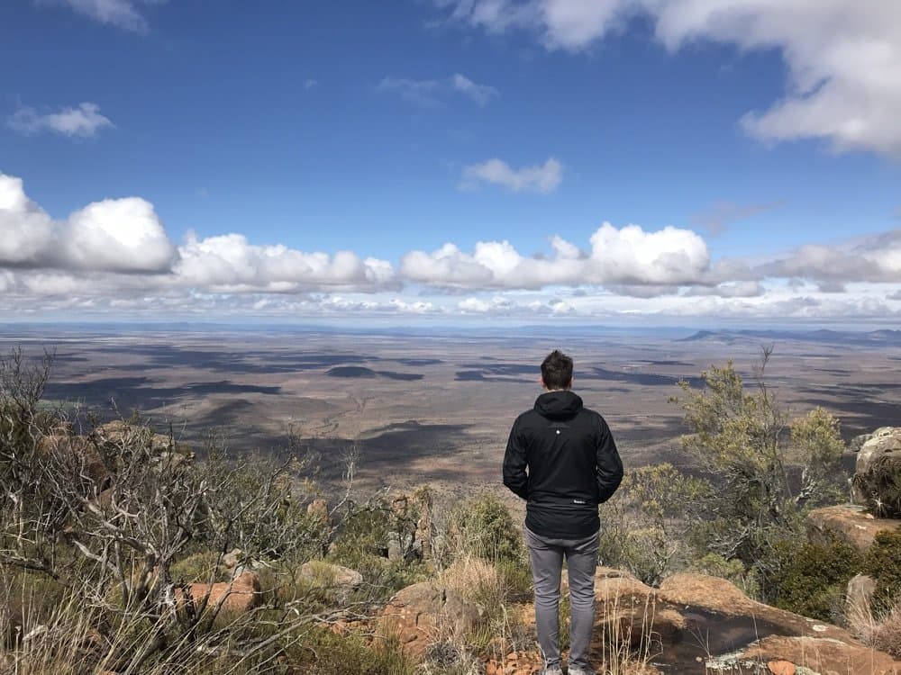 Looking out over a vast plain from a mountain summit